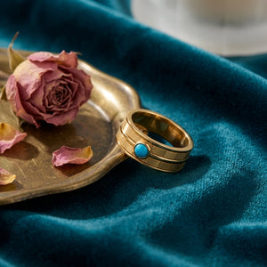 Firouzeh Turquoise Stacking Ring styled on teal surface with Persian tea