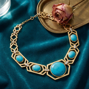 Firouzeh Turquoise Collar Necklace styled on teal surface
