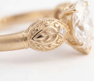 Sepideh engagement ring - close detail of boteh relief with hand-engraved interior and diamond accent