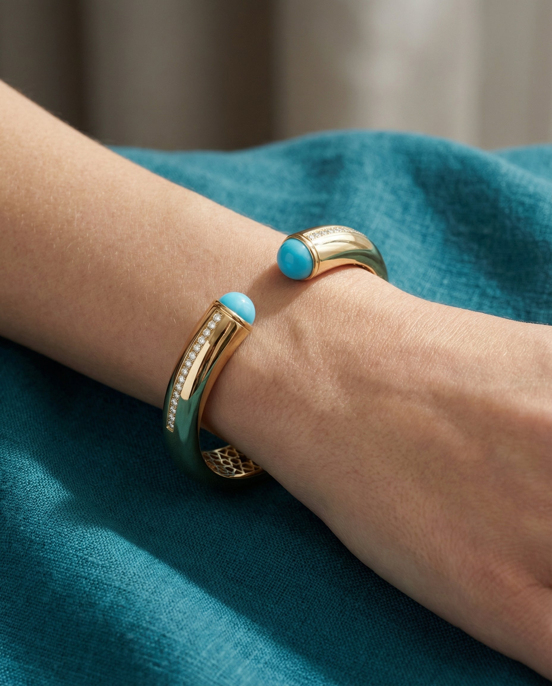 Firouzeh Turquoise Cuff Bracelet on hand against teal surface