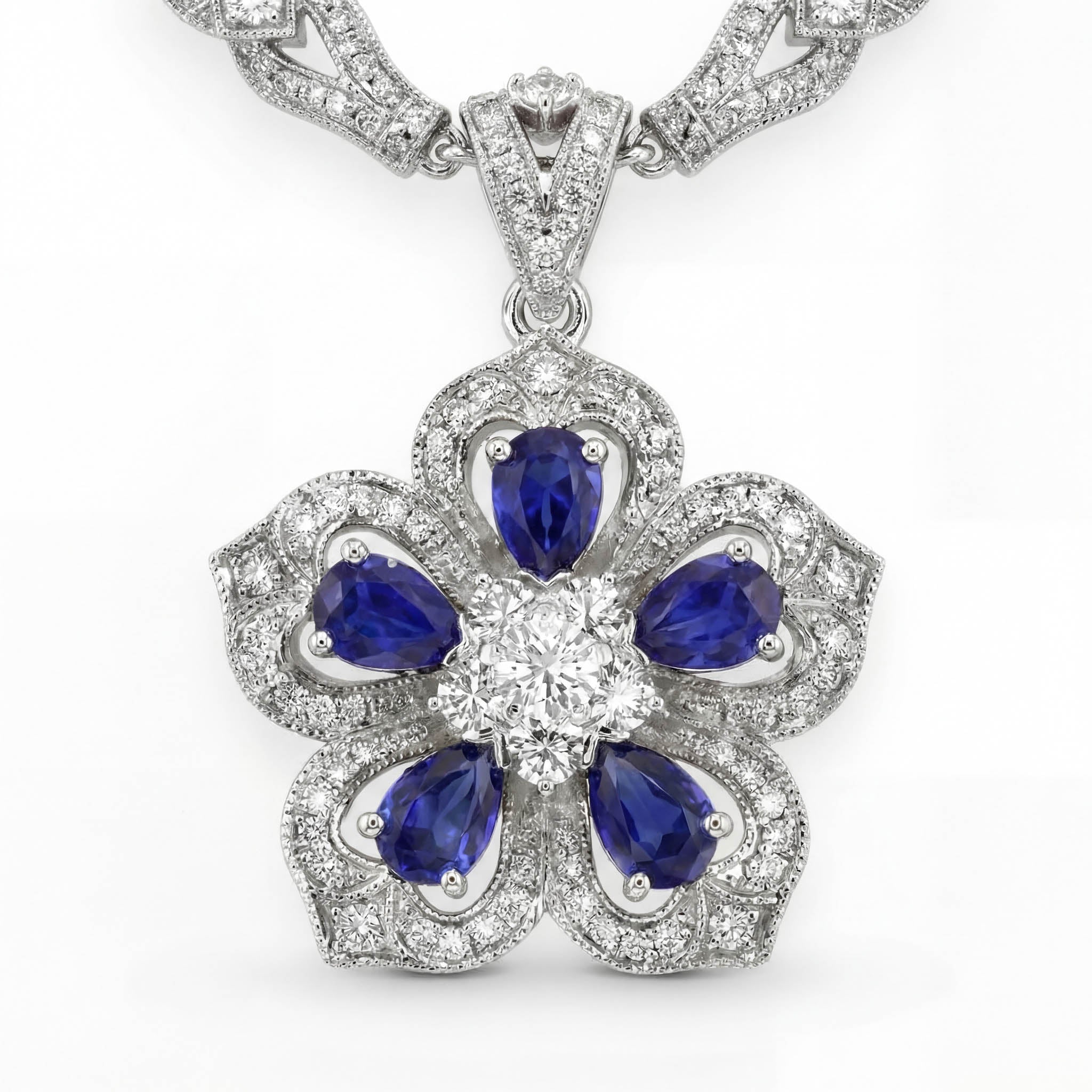 Gol-e Sefid platinum pendant with vivid blue sapphire and diamond halo by Silux London