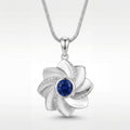 Gol-e Behesht pendant in 18ct white gold with blue sapphire centre by Silux London