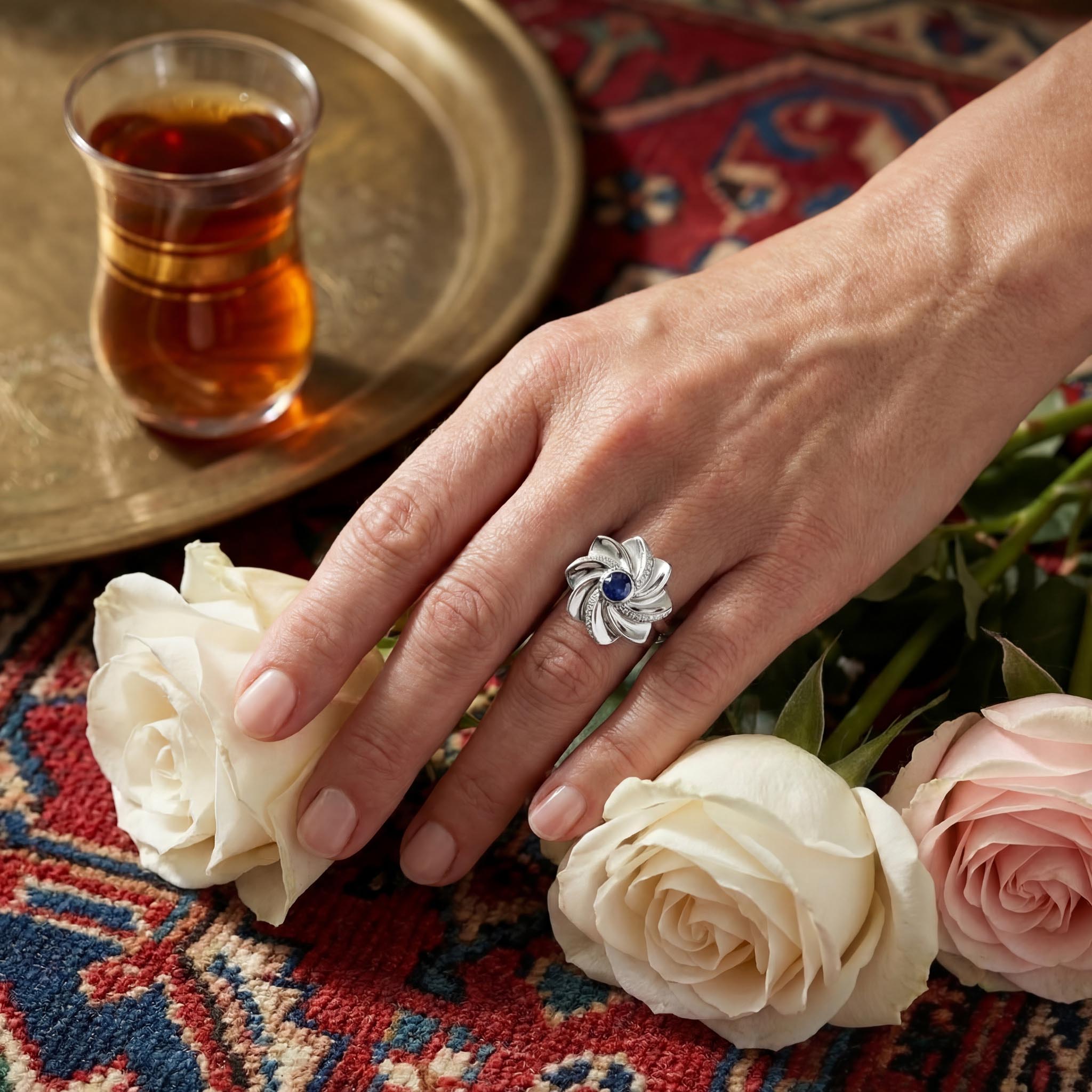 Gol-e Behesht ring close-up showing sapphire centre and diamond pave petals