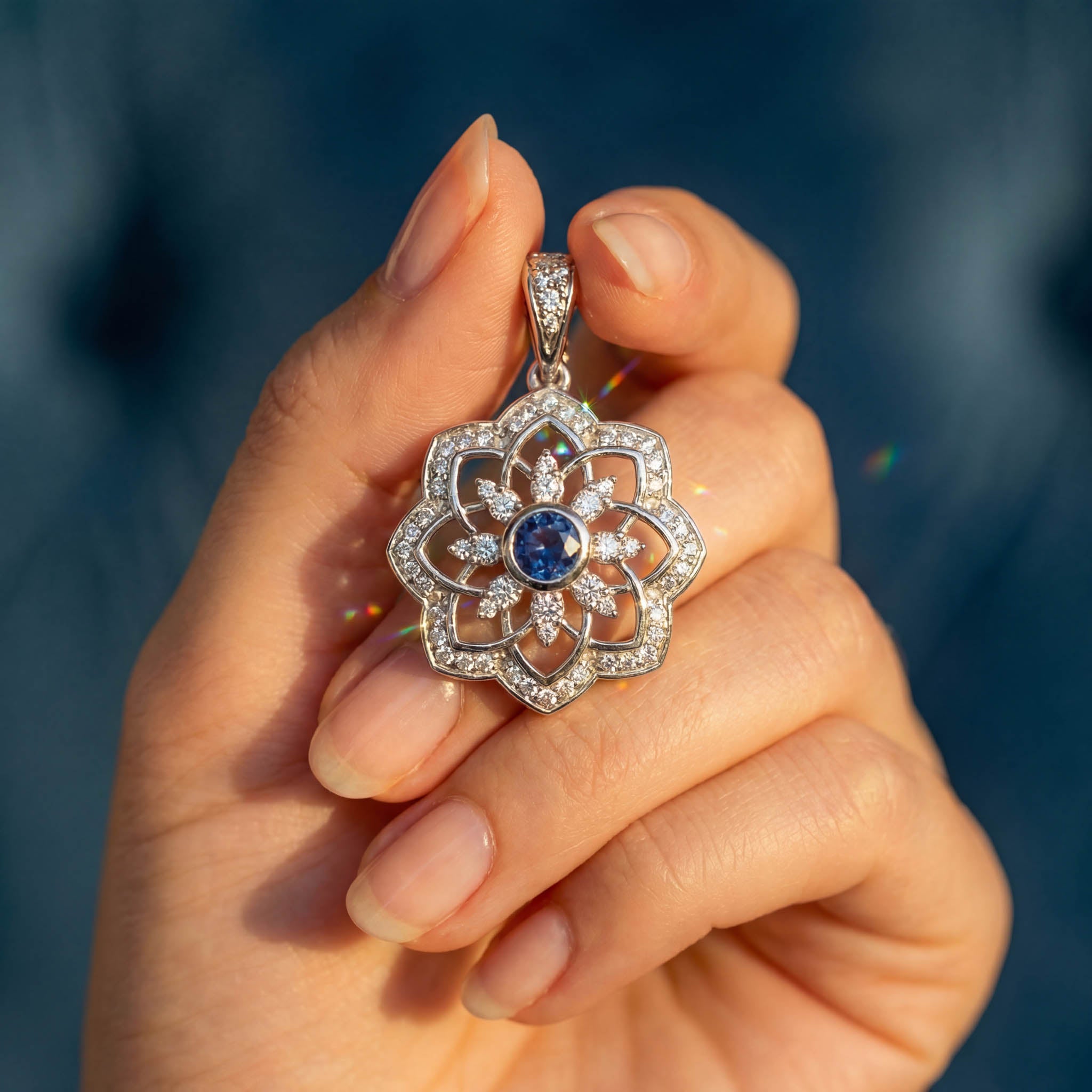 Gol-e Shab pendant detail, diamond-set petals around bezel-set sapphire