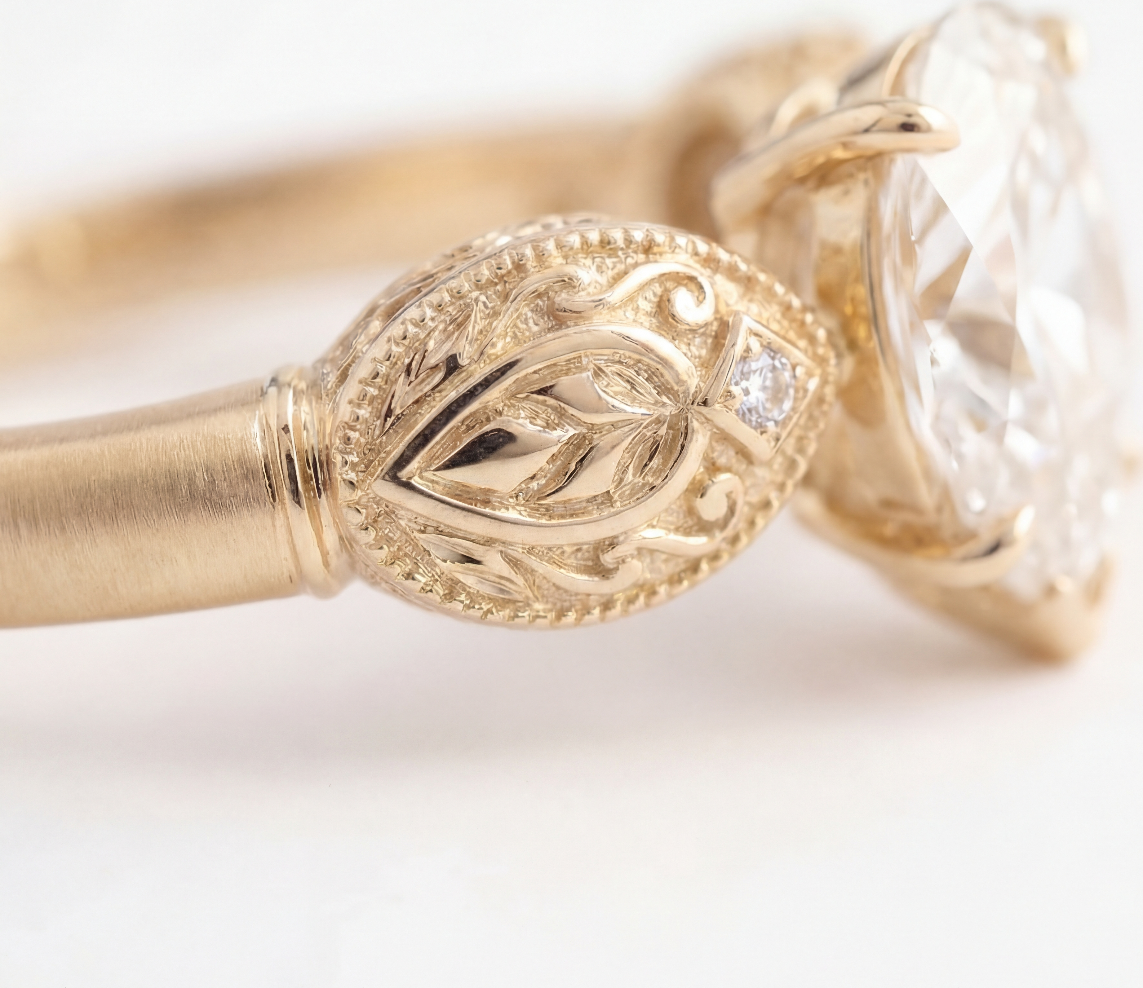 Sepideh engagement ring - close detail of boteh relief with hand-engraved interior and diamond accent